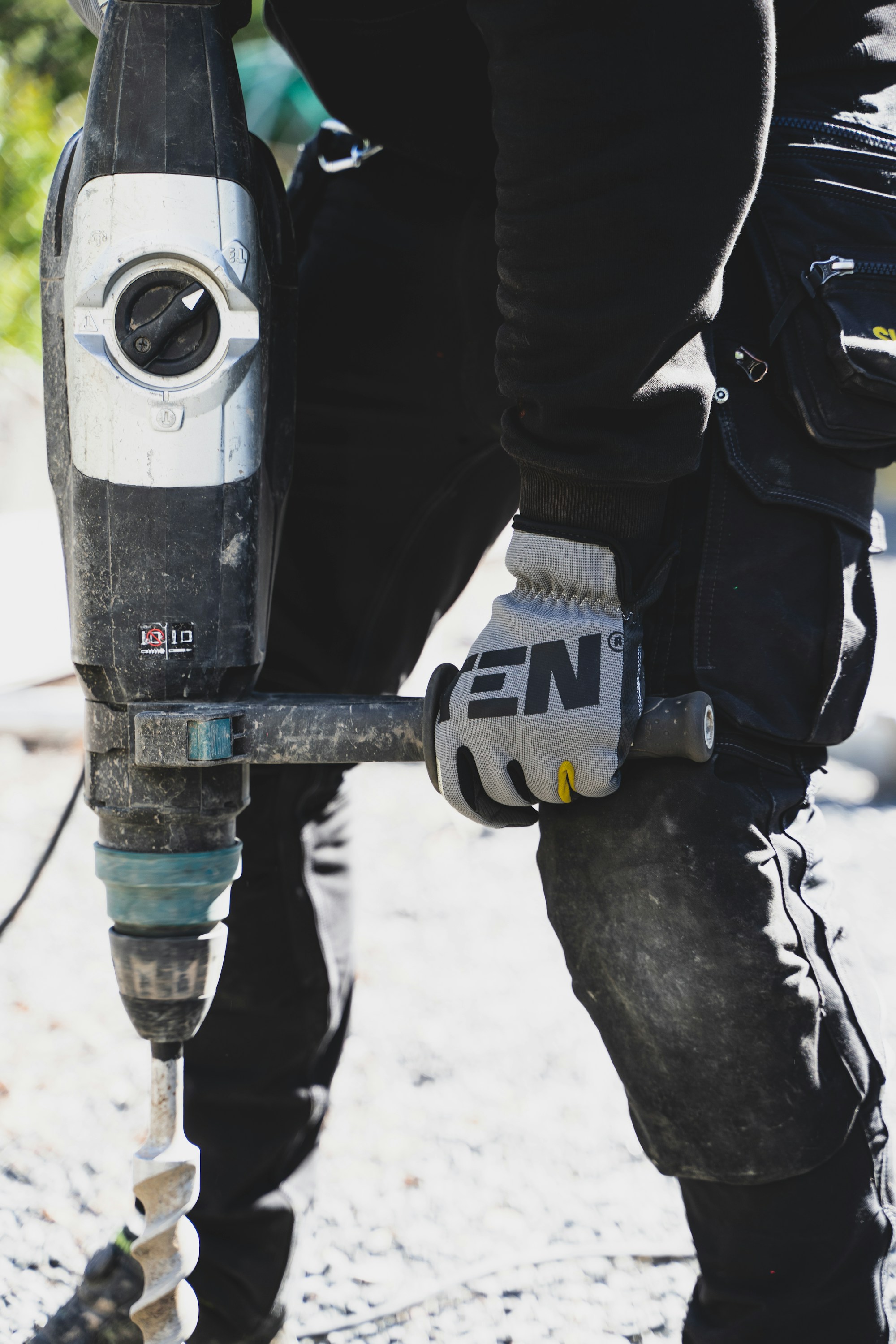 Person holding a drill during workplace health surveillance